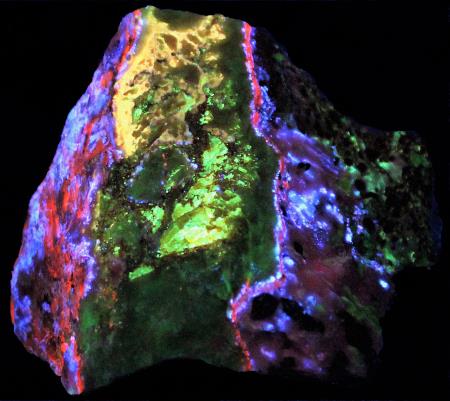 Fluorescent secondary zincite, sphalerite and willemite under longwave UV light.